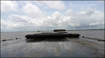 Barge rolls  into water with airbags from carrier deck